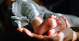 person holding baby feet